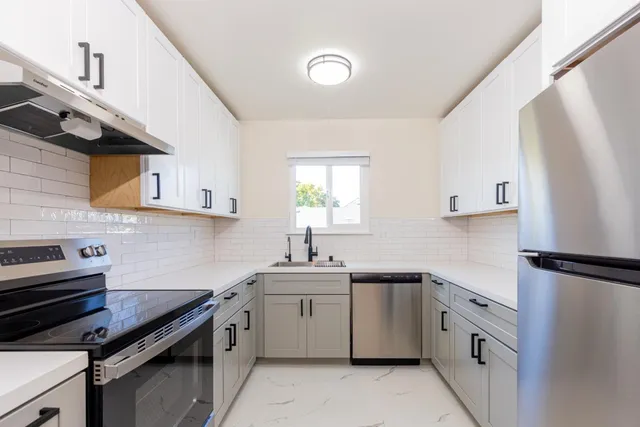 a view of kitchen and utility room with wooden floor