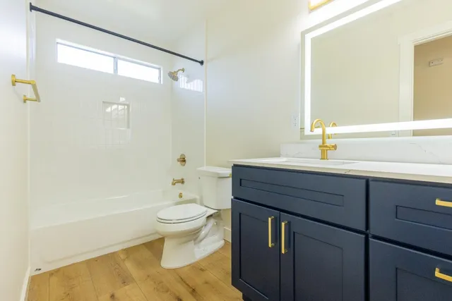 a kitchen with stainless steel appliances granite countertop a refrigerator sink and wooden cabinets