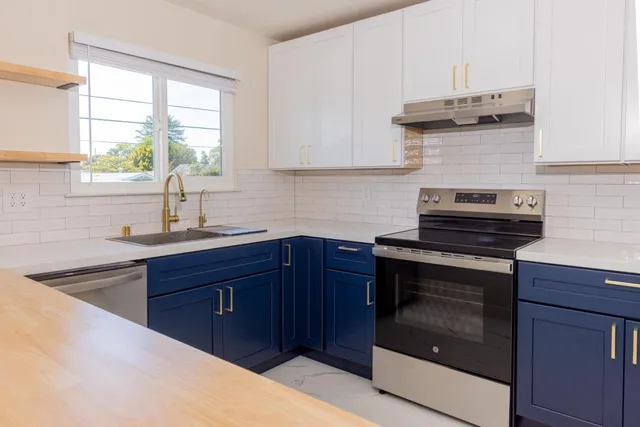 a backyard of a house with table and chairs plants