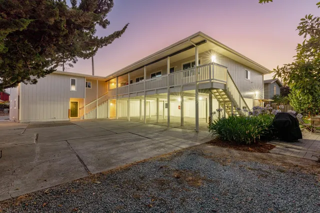 a backyard of a house with table and chairs