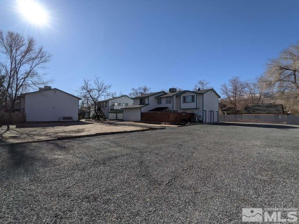 0 East 5th Carson City, NV 89701 - Photo 33 of 38 a large house with a large parking space and a car parked on the road