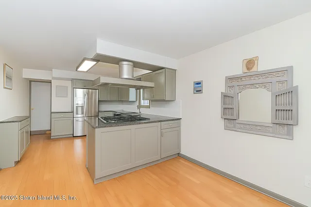 a kitchen with stainless steel appliances granite countertop a sink and a stove top oven