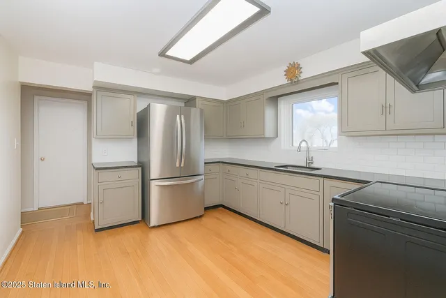 a kitchen with a sink cabinets and stainless steel appliances