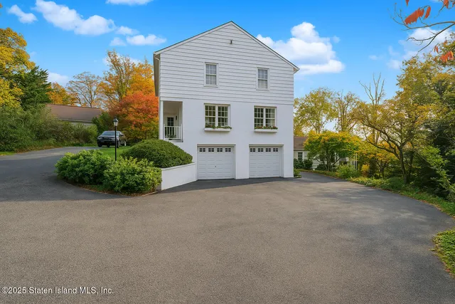 a view of a house with a yard and garage
