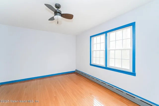 a view of a room with a window and a ceiling fan