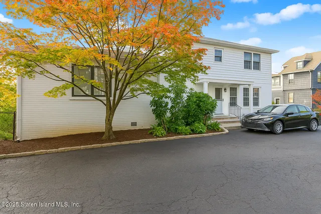 a couple of cars parked in front of a house