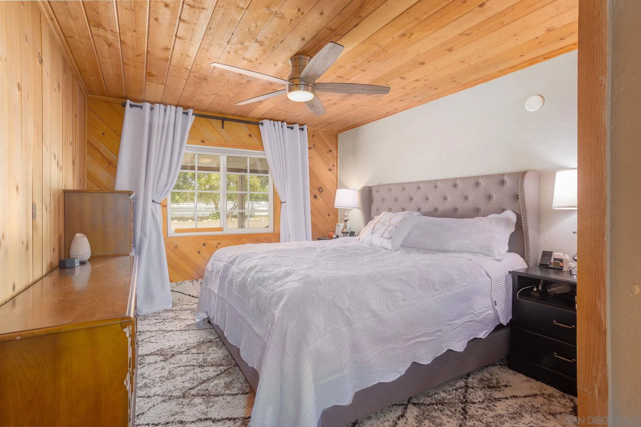 14066 Cool Valley Road Valley Center, CA 92082 - Photo 14 of 34 a bedroom with a bed and a large window