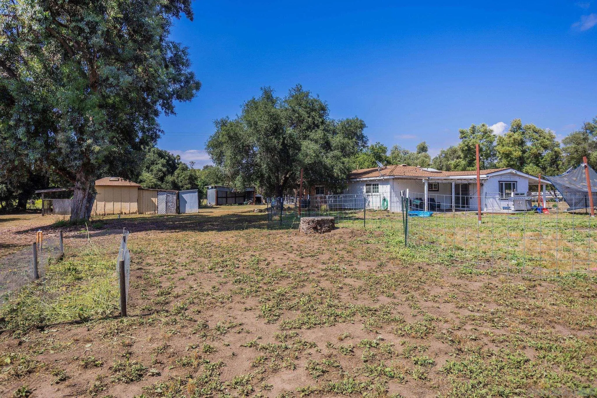 14066 Cool Valley Road Valley Center, CA 92082 - Photo 22 of 34 a front view of a house with a yard