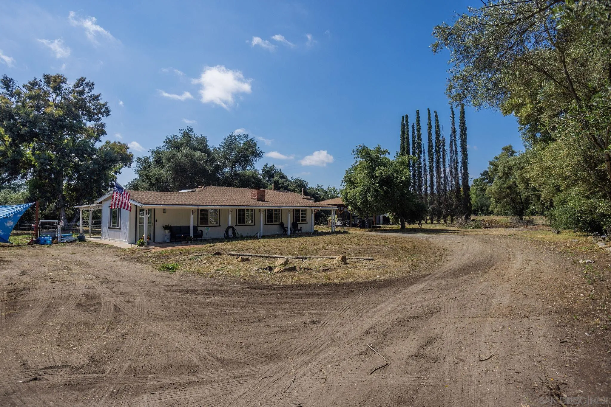 14066 Cool Valley Road Valley Center, CA 92082 - Photo 4 of 34 a view of a house with a yard and large trees