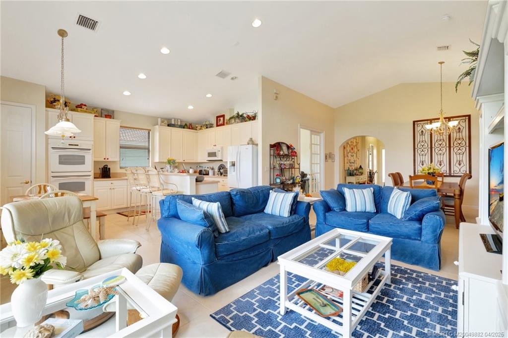5195 Southeast Graham Drive Stuart, FL 34997 - Photo 14 of 52 a living room with furniture fireplace and a chandelier