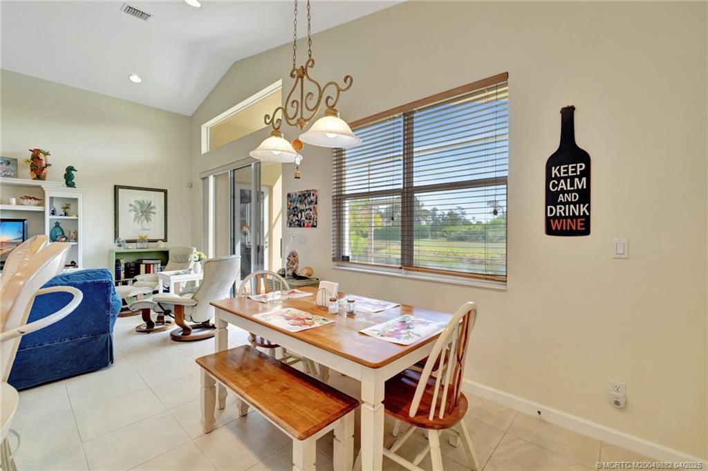 5195 Southeast Graham Drive Stuart, FL 34997 - Photo 16 of 52 a dining room with furniture a chandelier and window