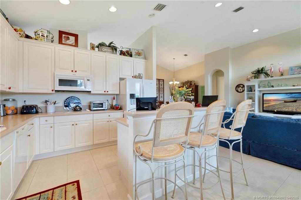 5195 Southeast Graham Drive Stuart, FL 34997 - Photo 17 of 52 a kitchen with stainless steel appliances cabinets a refrigerator and a stove top oven
