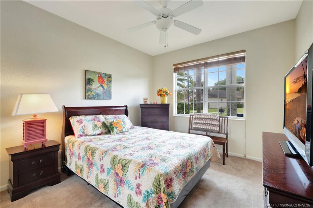 5195 Southeast Graham Drive Stuart, FL 34997 - Photo 21 of 52 a bedroom with a bed and a flat screen tv