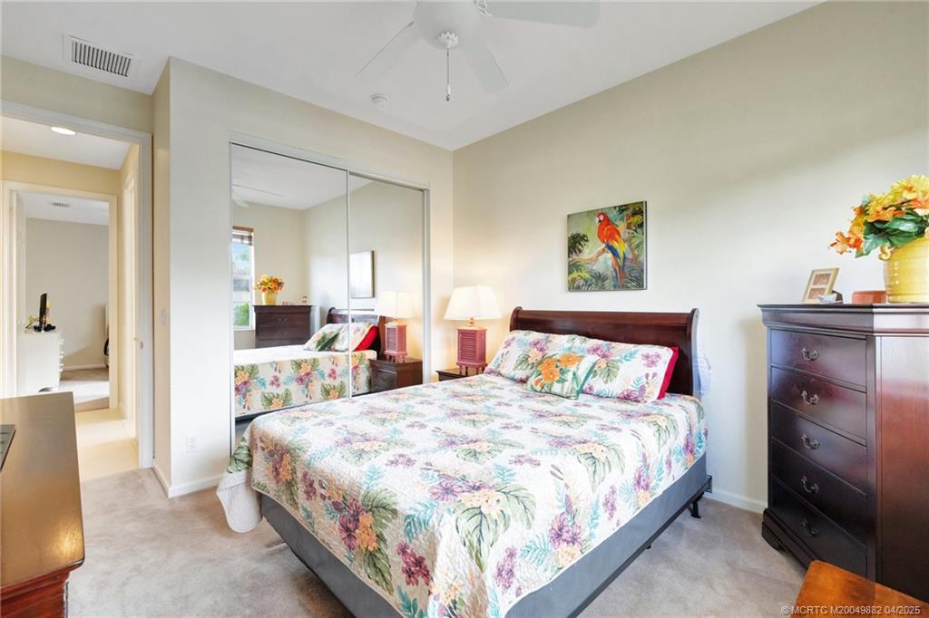 5195 Southeast Graham Drive Stuart, FL 34997 - Photo 22 of 52 a bed room with a bed and a chandelier