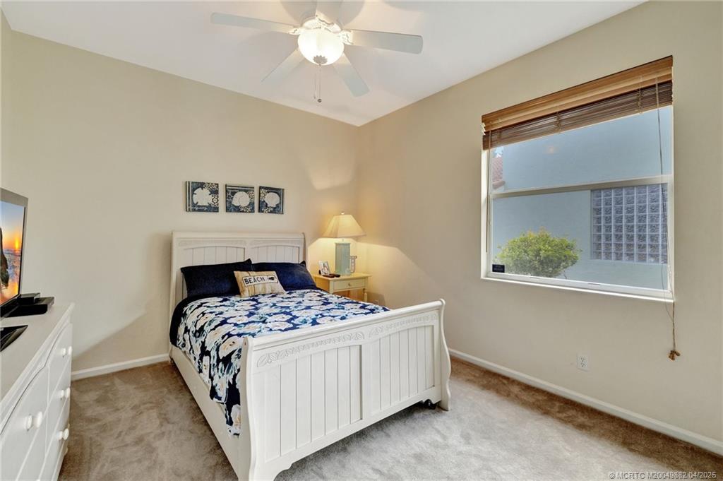 5195 Southeast Graham Drive Stuart, FL 34997 - Photo 25 of 52 a bedroom with a bed and a window