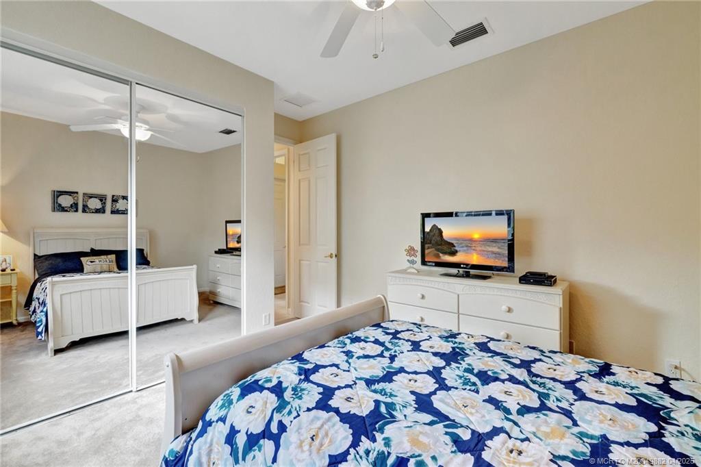 5195 Southeast Graham Drive Stuart, FL 34997 - Photo 26 of 52 a bedroom with furniture and a flat screen tv