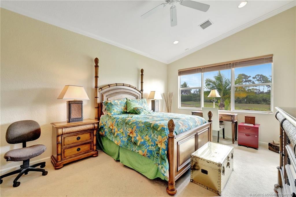5195 Southeast Graham Drive Stuart, FL 34997 - Photo 27 of 52 a bedroom with a bed and large windows