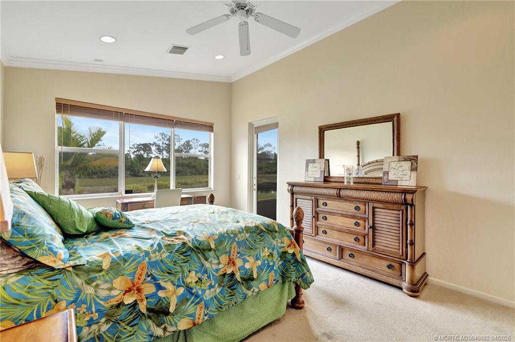 5195 Southeast Graham Drive Stuart, FL 34997 - Photo 28 of 52 a bedroom with a bed and a dresser