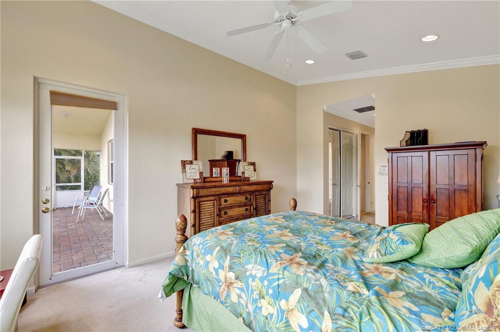 5195 Southeast Graham Drive Stuart, FL 34997 - Photo 30 of 52 a bedroom with a bed and a dresser in it