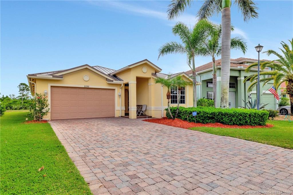 5195 Southeast Graham Drive Stuart, FL 34997 - Photo 3 of 52 a front view of a house with a garden