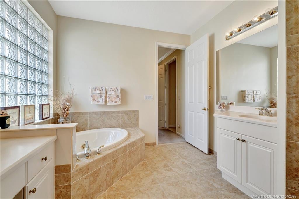 5195 Southeast Graham Drive Stuart, FL 34997 - Photo 32 of 52 a bathroom with a tub sink and mirror