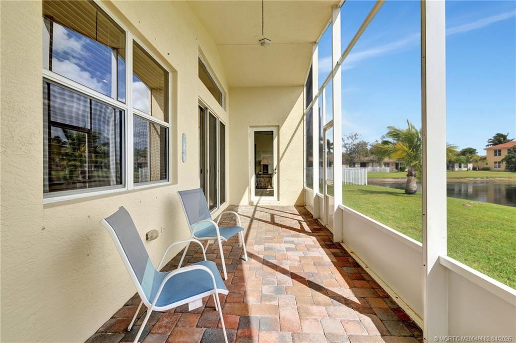 5195 Southeast Graham Drive Stuart, FL 34997 - Photo 35 of 52 a view of a patio with lawn chairs floor to ceiling window and floor to ceiling window
