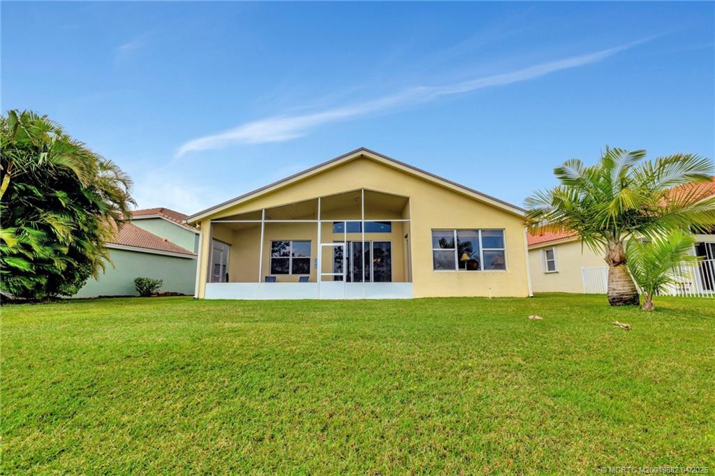 5195 Southeast Graham Drive Stuart, FL 34997 - Photo 38 of 52 a front view of a house with a yard and trees
