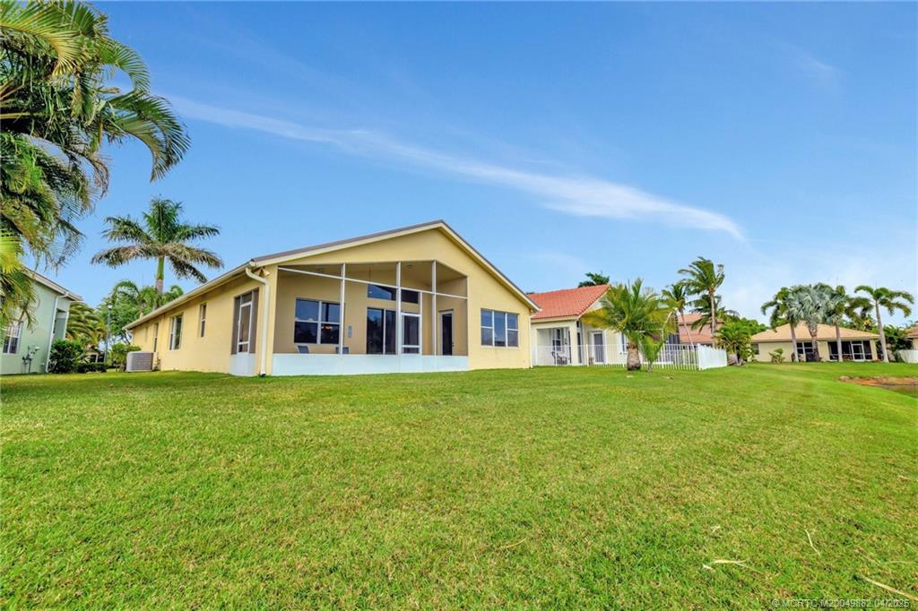 5195 Southeast Graham Drive Stuart, FL 34997 - Photo 39 of 52 a front view of a house with a yard and trees