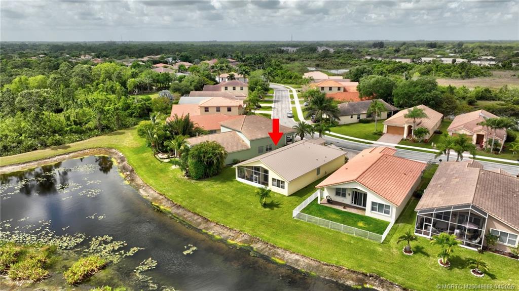 5195 Southeast Graham Drive Stuart, FL 34997 - Photo 46 of 52 an aerial view of a house with a garden and lake view