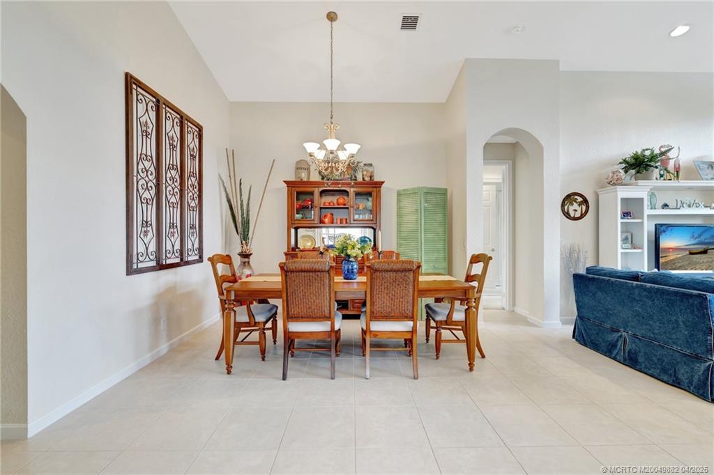 5195 Southeast Graham Drive Stuart, FL 34997 - Photo 7 of 52 a dining room with furniture a chandelier and window