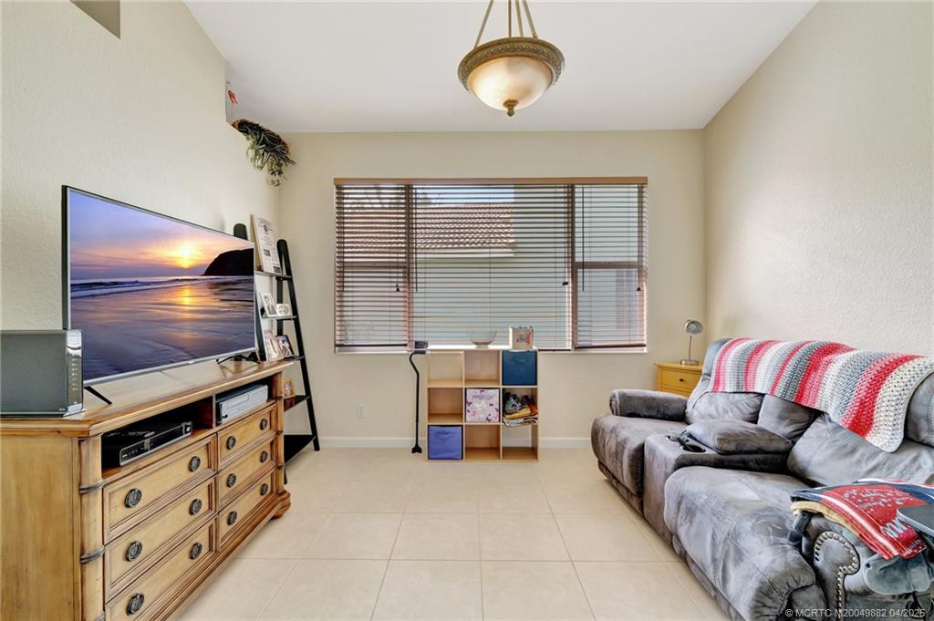 5195 Southeast Graham Drive Stuart, FL 34997 - Photo 10 of 52 a living room with furniture and a flat screen tv