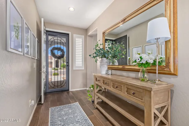 a kitchen with granite countertop kitchen island stainless steel appliances a refrigerator a stove a sink a center island and chairs