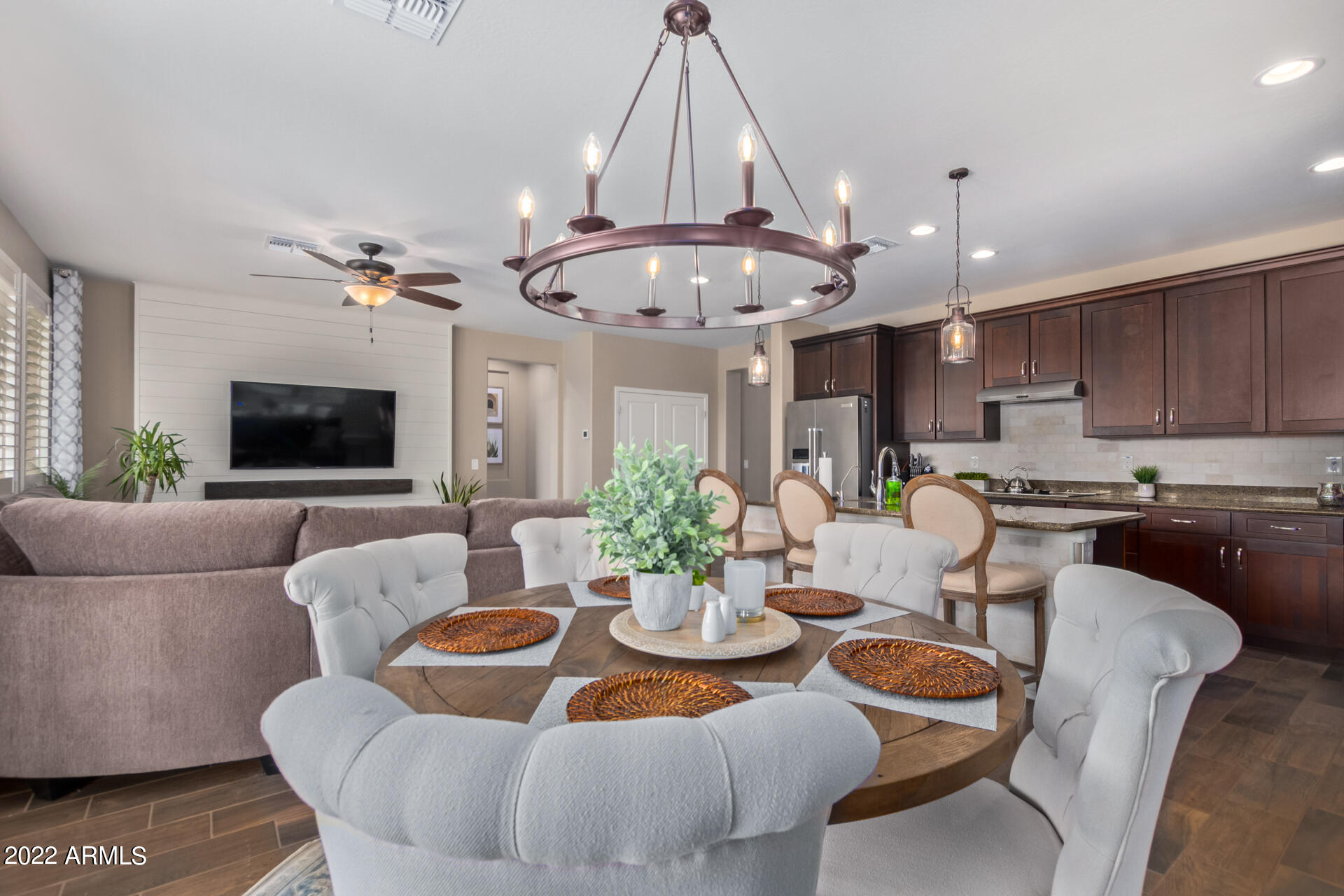 22503 East Calle De Flores Queen Creek, AZ 85142 - Photo 16 of 57 a view of a dining room with furniture a kitchen and chandelier