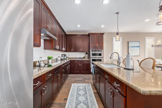 a view of a kitchen area with furniture and wooden floor