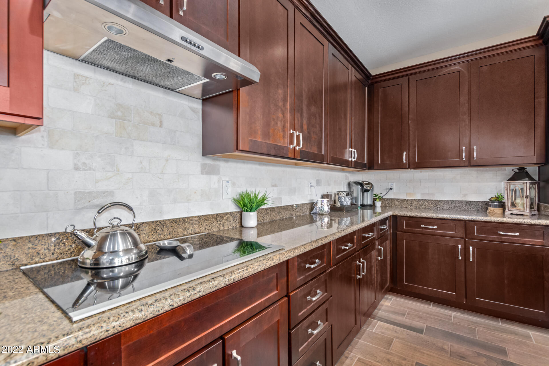 22503 East Calle De Flores Queen Creek, AZ 85142 - Photo 20 of 57 a kitchen with granite countertop a sink a stove and cabinets