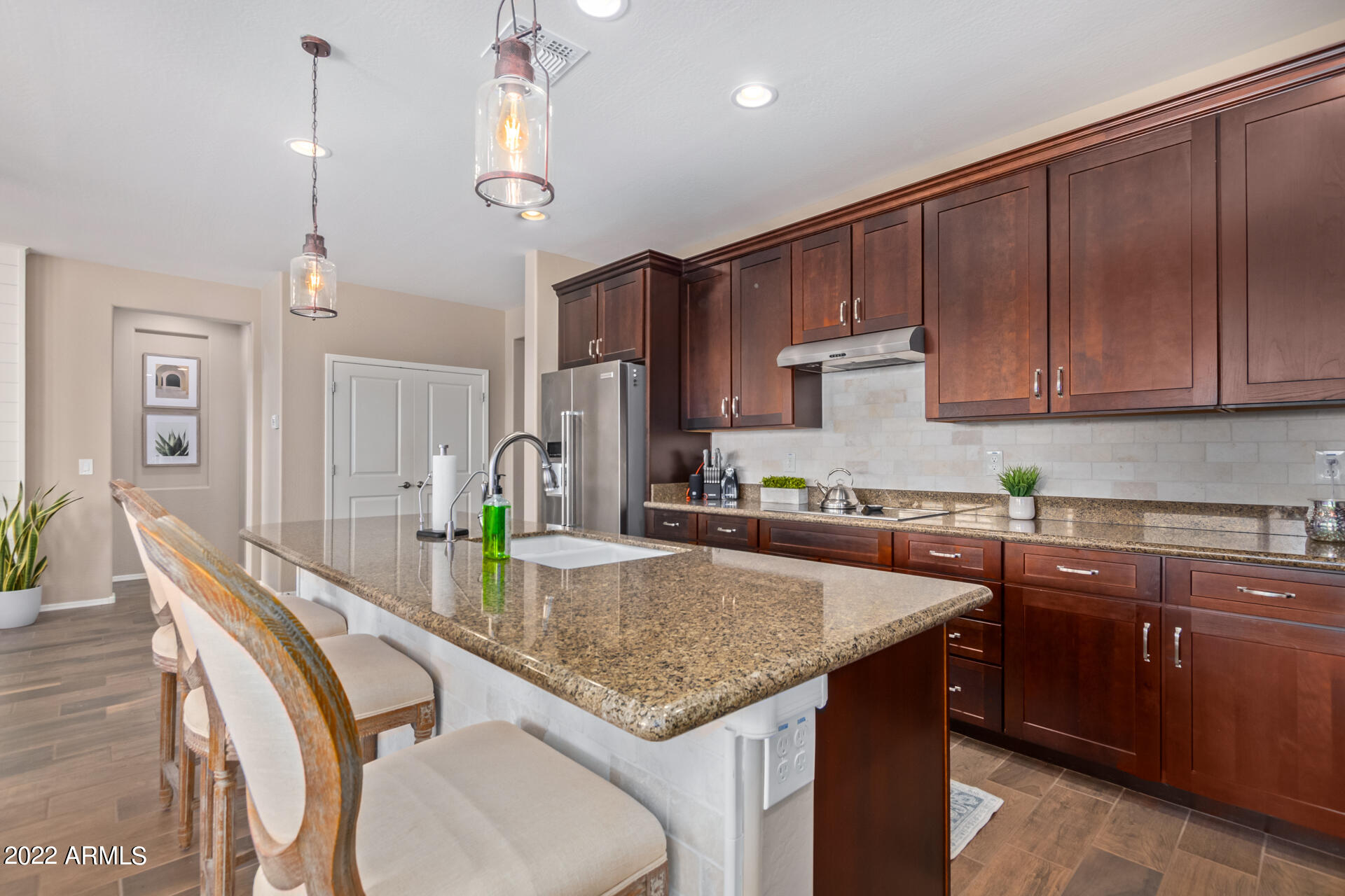 22503 East Calle De Flores Queen Creek, AZ 85142 - Photo 22 of 57 a kitchen that has a cabinets counter space and wooden floor