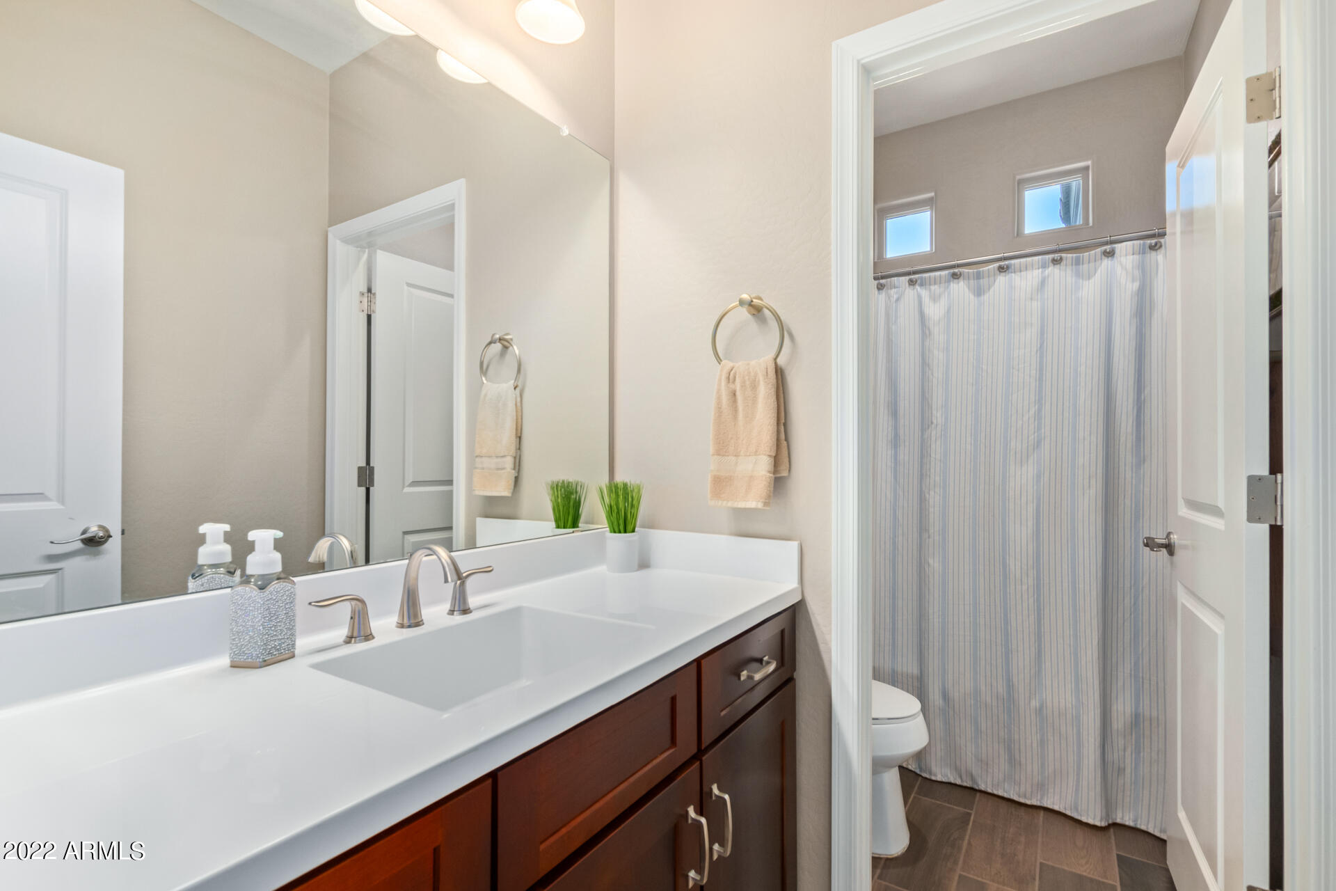 22503 East Calle De Flores Queen Creek, AZ 85142 - Photo 30 of 57 a bathroom with a double vanity sink and mirror