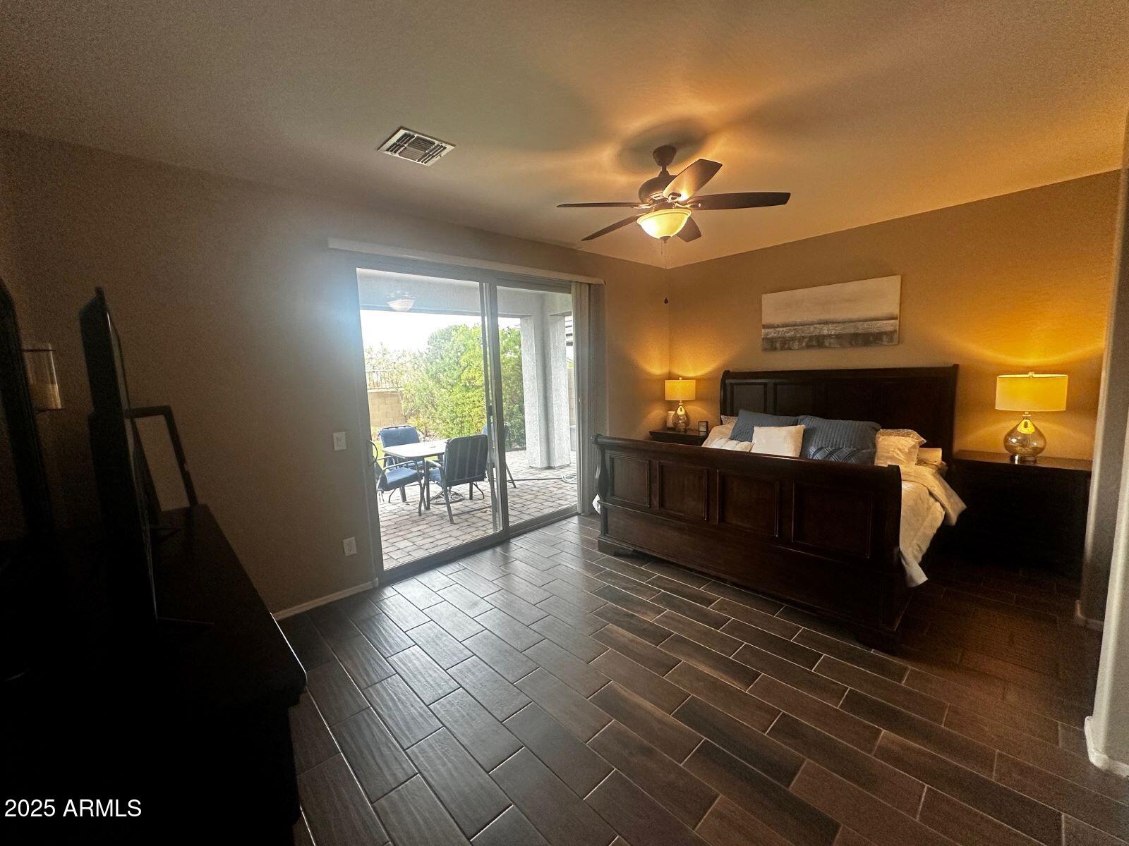 22503 East Calle De Flores Queen Creek, AZ 85142 - Photo 3 of 57 a bed room with furniture and a chandelier