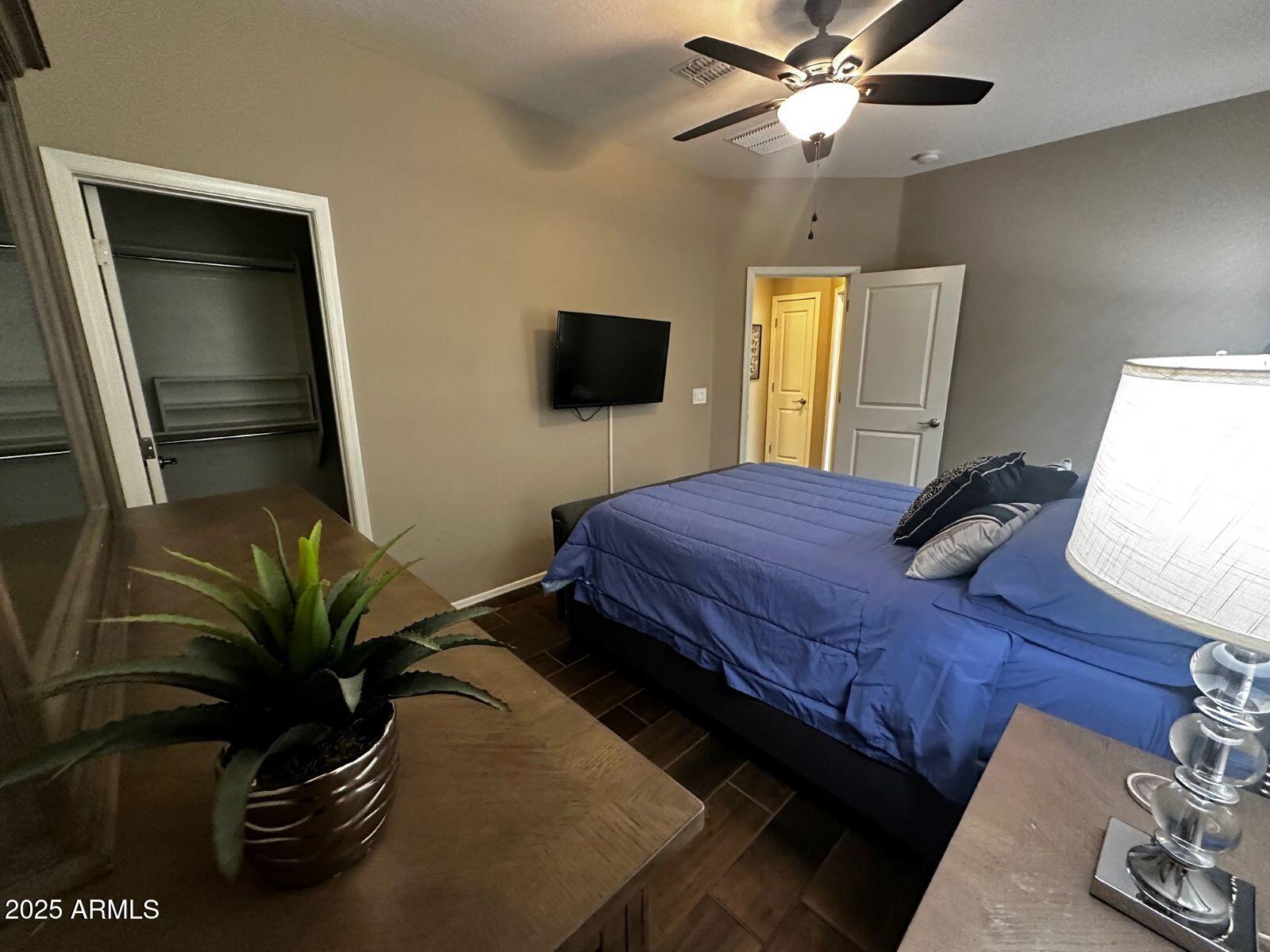 22503 East Calle De Flores Queen Creek, AZ 85142 - Photo 32 of 57 a bedroom with a bed and a television