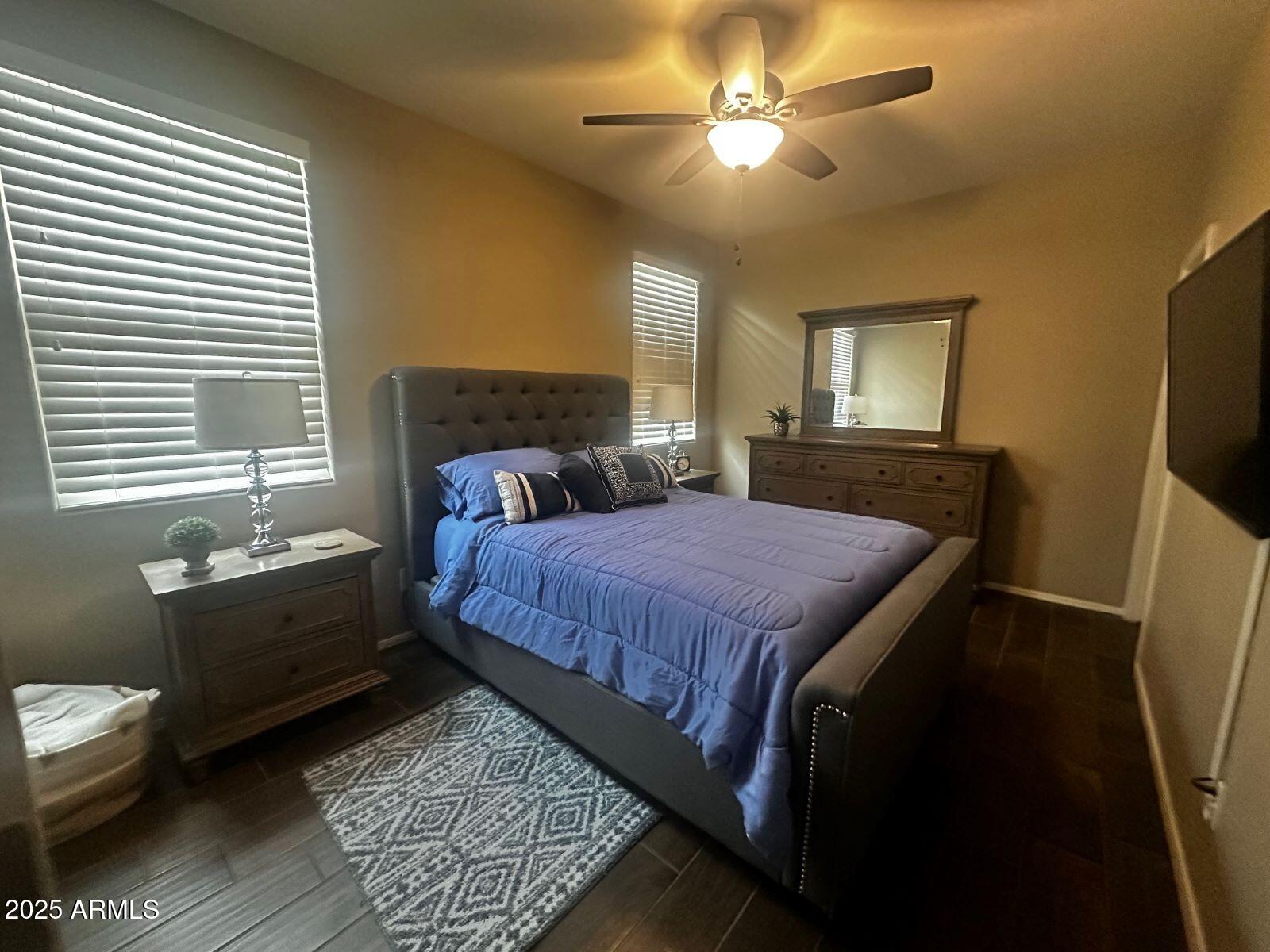 22503 East Calle De Flores Queen Creek, AZ 85142 - Photo 4 of 57 a bed sitting in a bedroom next to a window