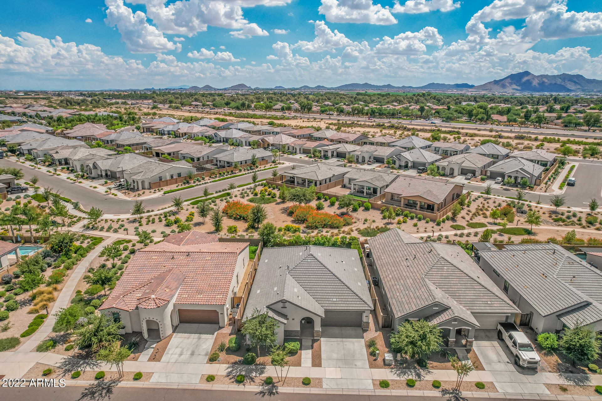 22503 East Calle De Flores Queen Creek, AZ 85142 - Photo 42 of 57 an aerial view of residential houses with outdoor space