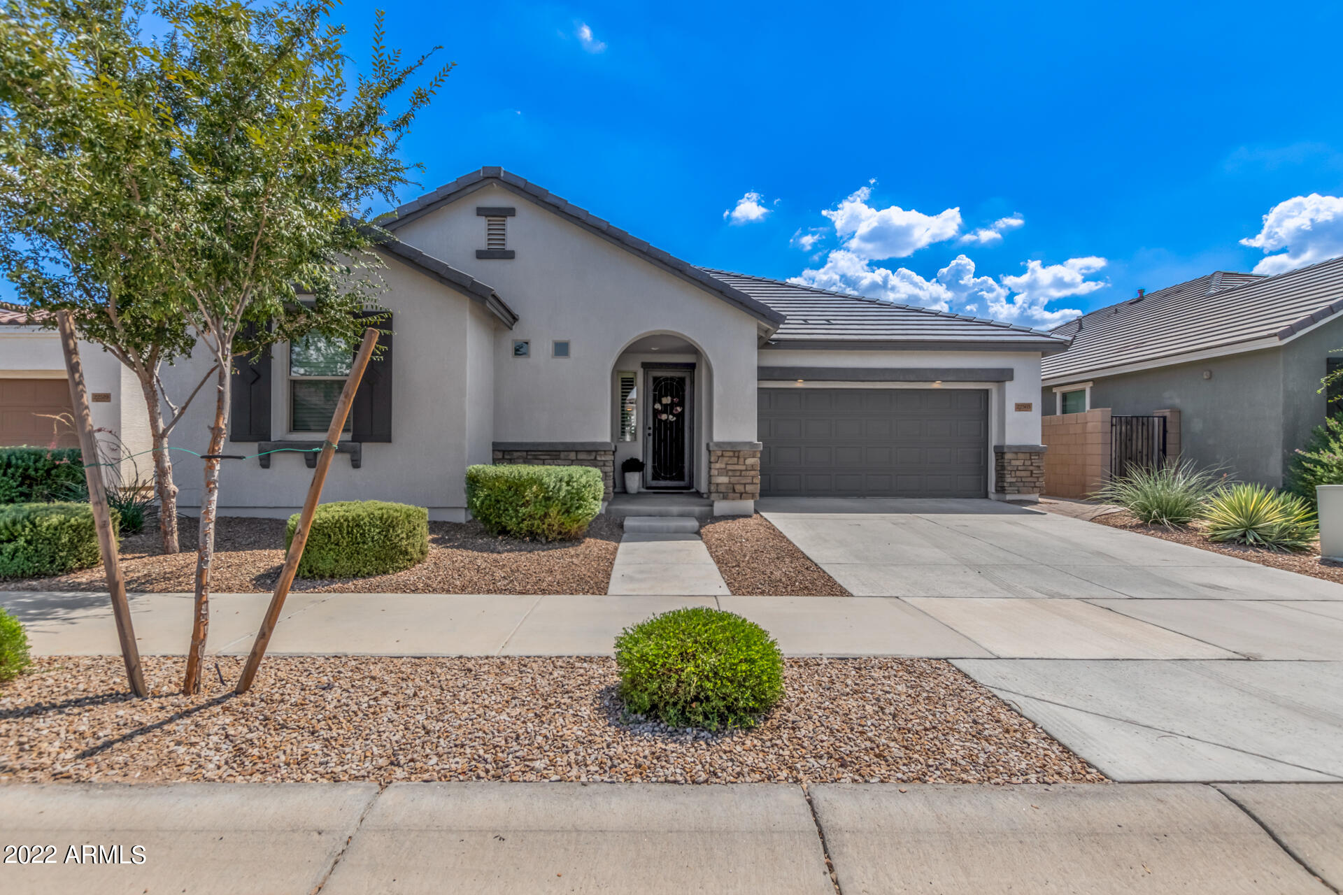 22503 East Calle De Flores Queen Creek, AZ 85142 - Photo 8 of 57 a front view of a house with garden