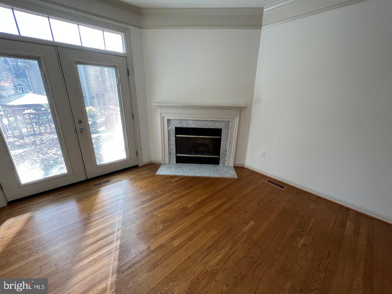 17911 Dumfries Circle Olney, MD 20832 - Photo 16 of 29 a view of an empty room with wooden floor fireplace and a window