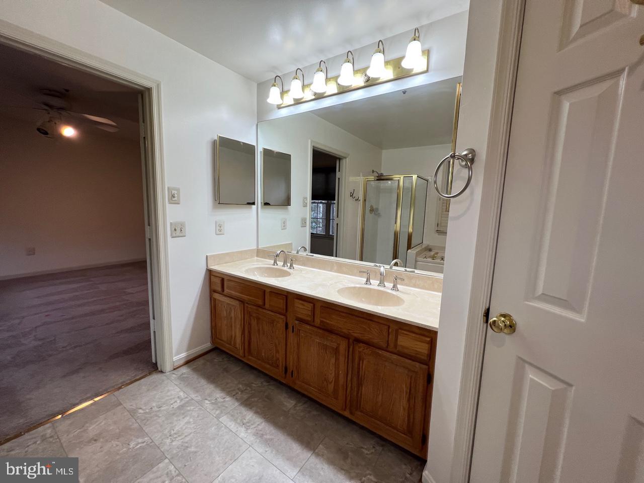 17911 Dumfries Circle Olney, MD 20832 - Photo 21 of 29 a bathroom with a double vanity sink and a mirror