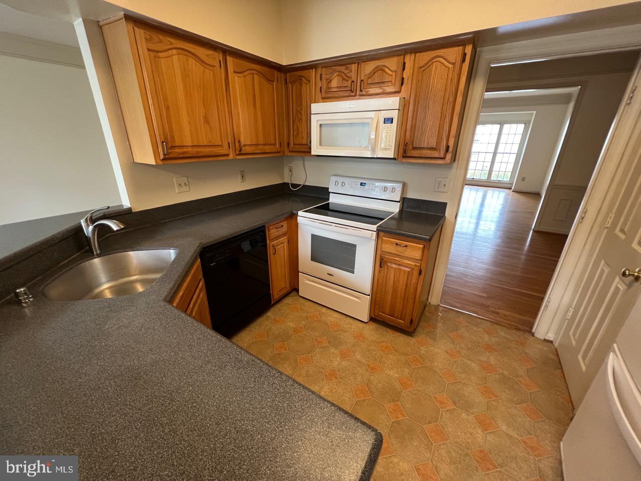 17911 Dumfries Circle Olney, MD 20832 - Photo 3 of 29 a kitchen with stainless steel appliances granite countertop a sink stove and microwave