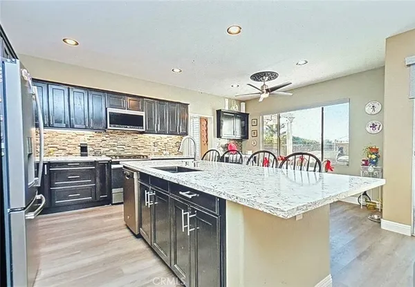 a kitchen with counter top space cabinets and appliances