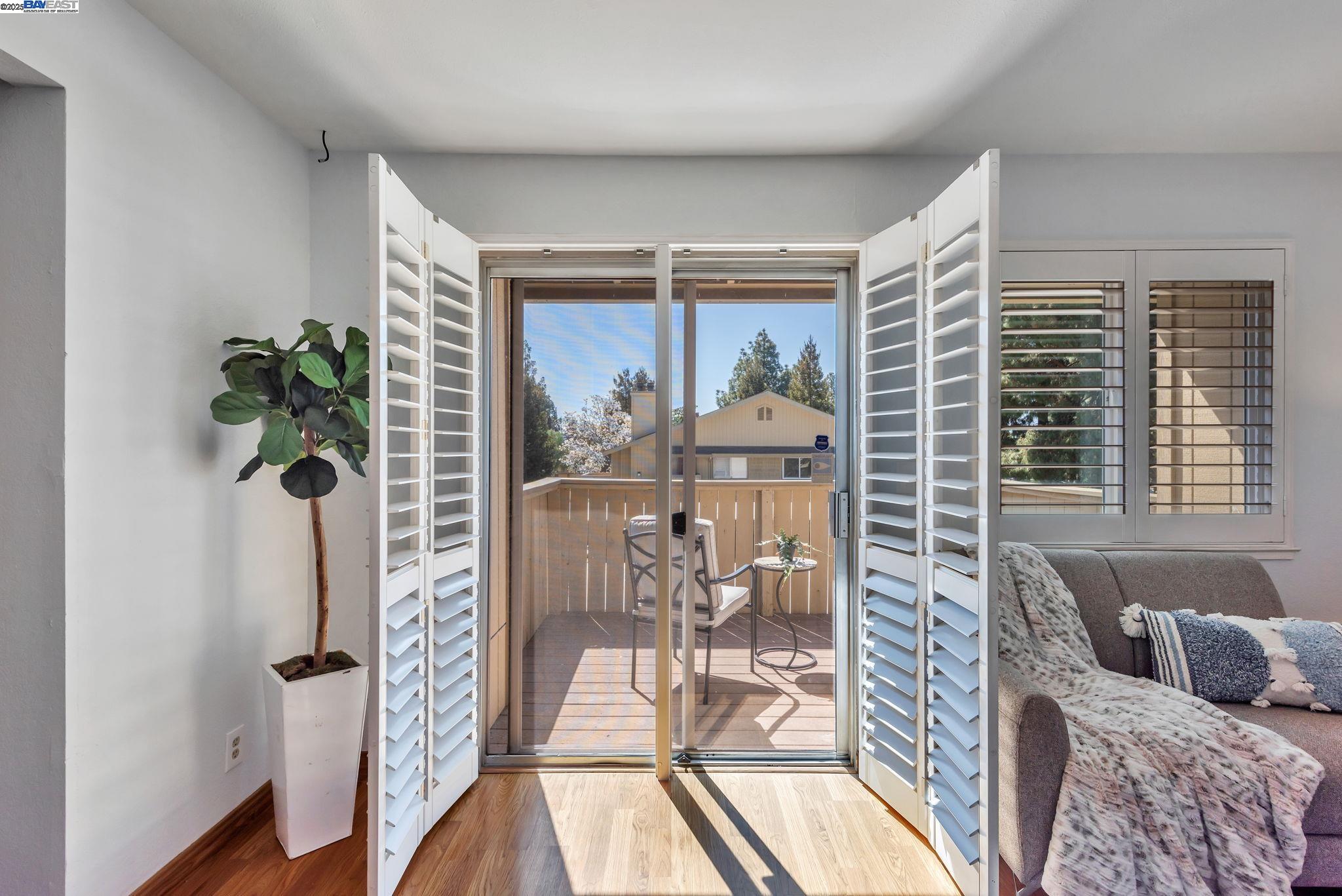 46907 Fernald Common Fremont, CA 94539 - Photo 1 of 1 a living room with furniture and a floor to ceiling window