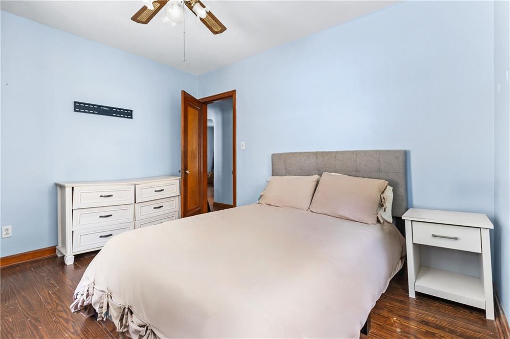 118 Oak Spring Road Canonsburg, PA 15317 - Photo 16 of 32 Comfortable bedroom with hardwood floors and calm blue walls, featuring closet space and room for a full bedroom setup. Neutral design makes it move-in ready.