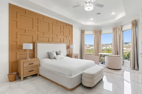 a large spacious bathroom with a granite countertop tub shower double sink and mirror