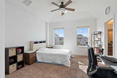 a living room with furniture floor to ceiling windows and a flat screen tv